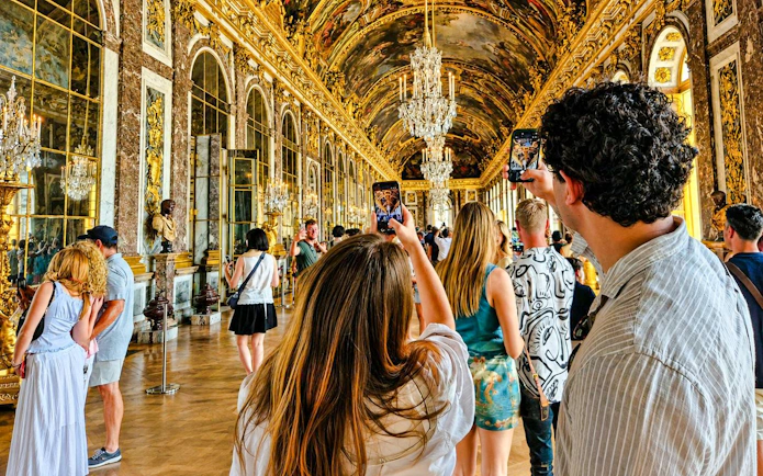 Visitors exploring the Hall of Mirrors at Versailles Palace during a private guided tour.