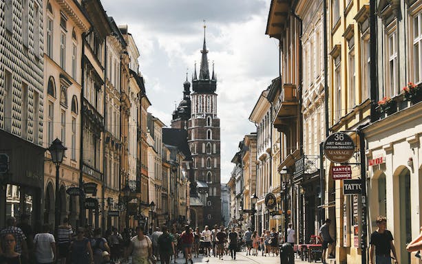 Krakow Old Town street view with St. Mary's Basilica in the background.