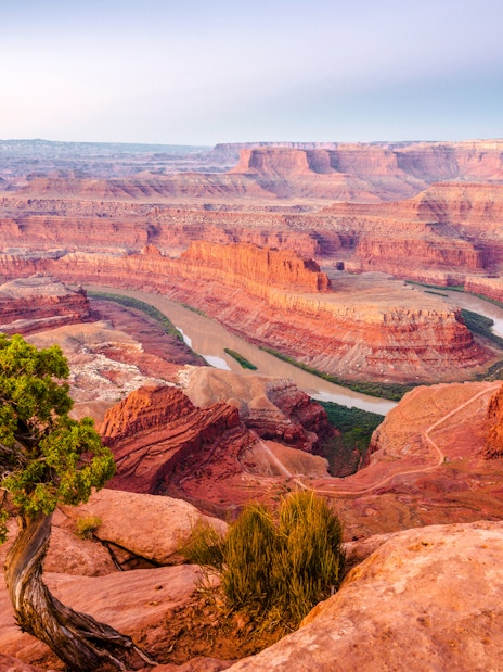 Grand Canyon view with winding river and rugged red rock formations.