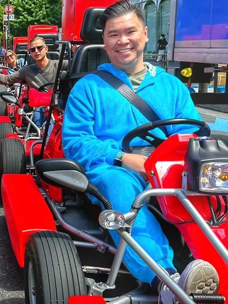 Tourists in costumes driving go-karts on the street in Akihabara, Tokyo.