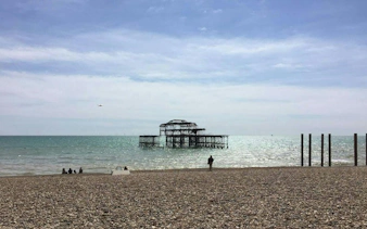 Brighton's West Pier ruins viewed from the pebble beach, part of the self-guided city exploration game.