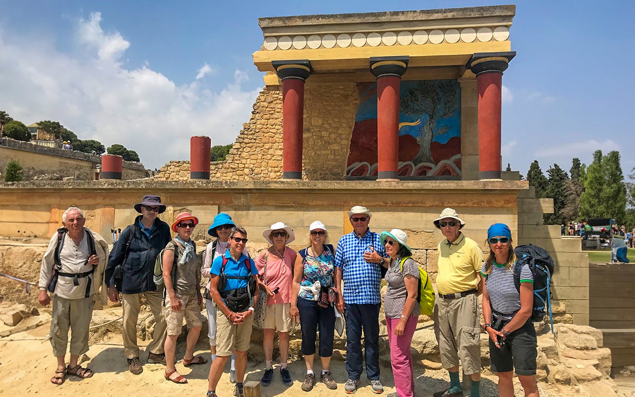 Tour group exploring ancient ruins at Knossos Palace, Crete.