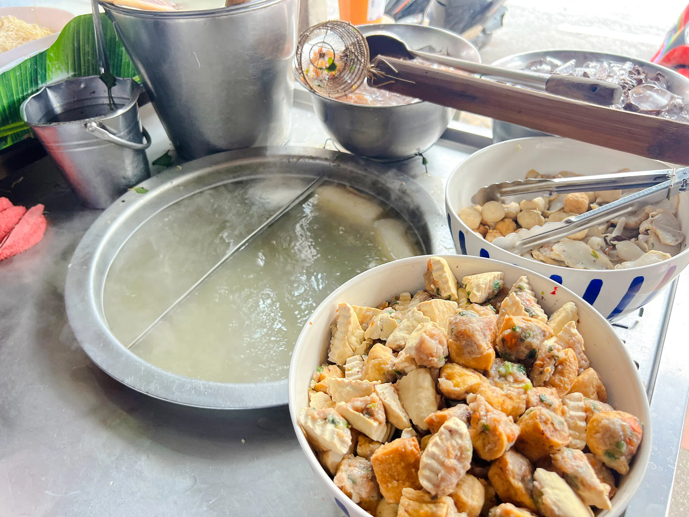 Street food preparation with assorted ingredients for noodle soup on the Taste of Chiang Mai Michelin Food Walking Tour.