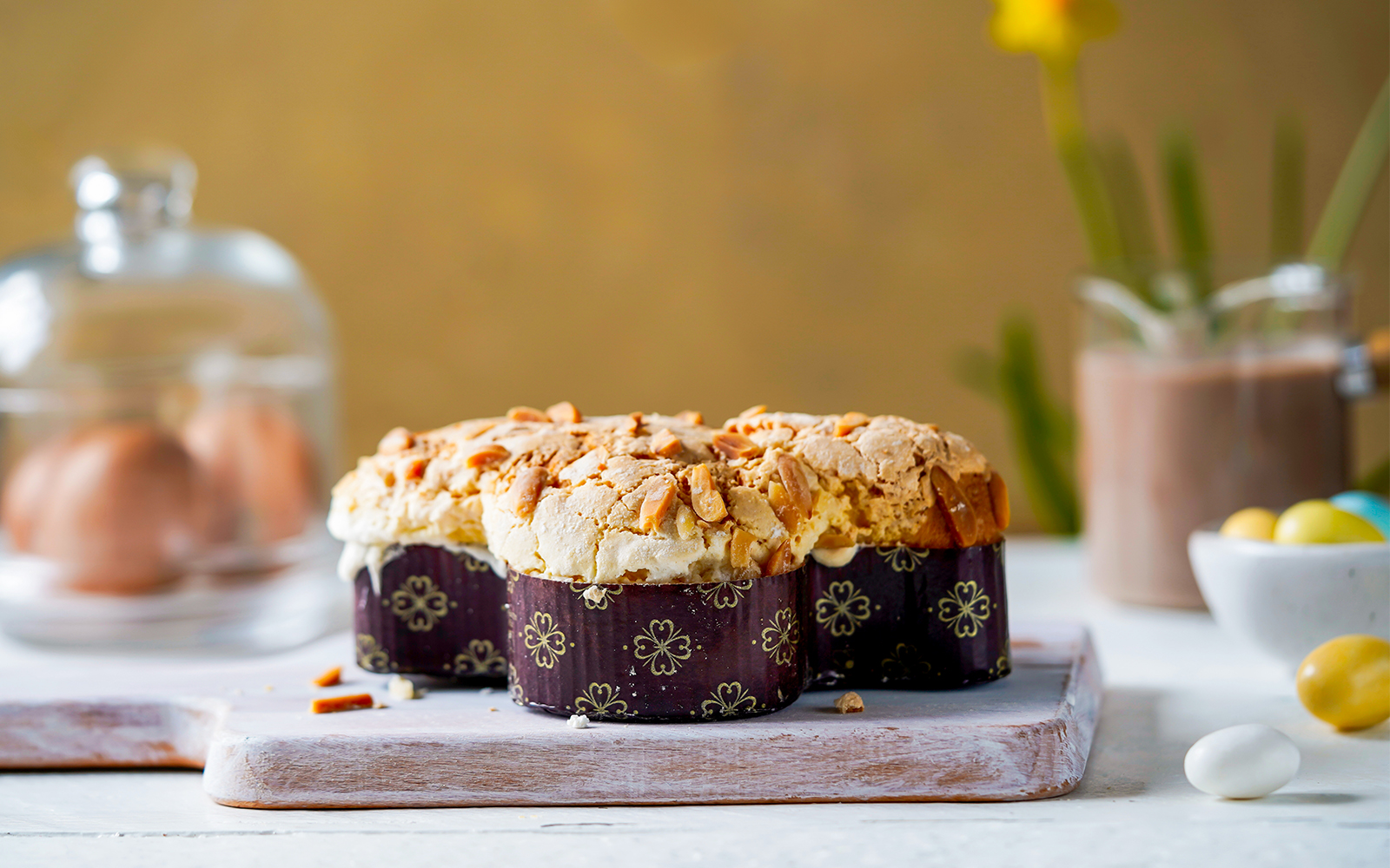 Colomba di Pasqua cake with almond topping in a festive spring setting, Italy.