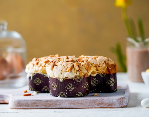 Colomba di Pasqua cake with almond topping in a festive spring setting, Italy.