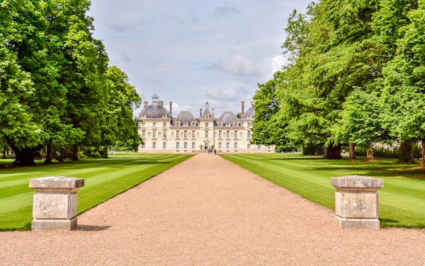 Chavenry Castle with tree-lined path and manicured lawns.