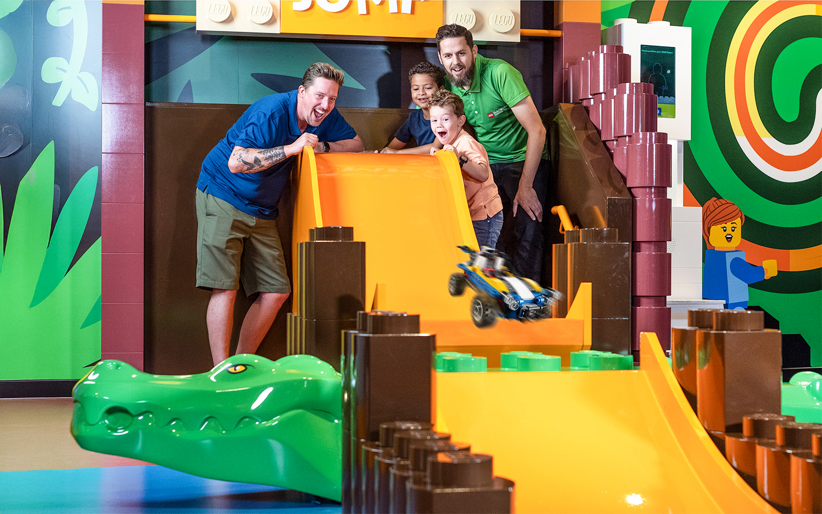 Children playing with a LEGO car on a slide at LEGO Discovery Centre Hamburg.