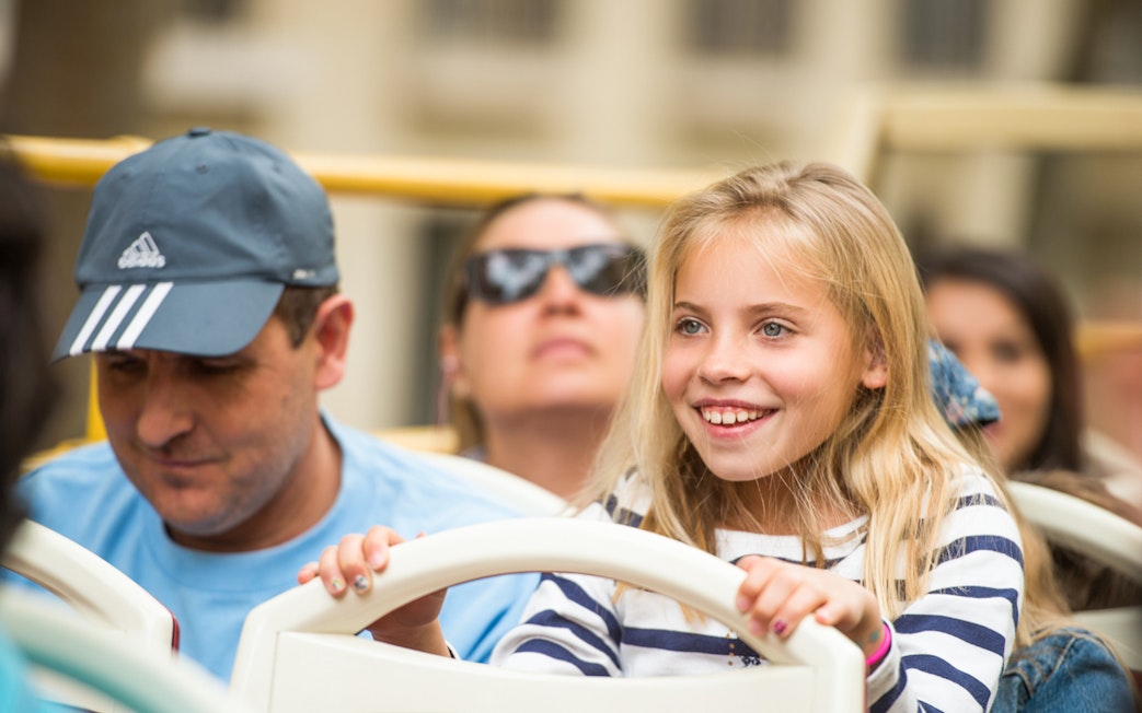 Children enjoying the view from a Munich hop-on hop-off bus tour.