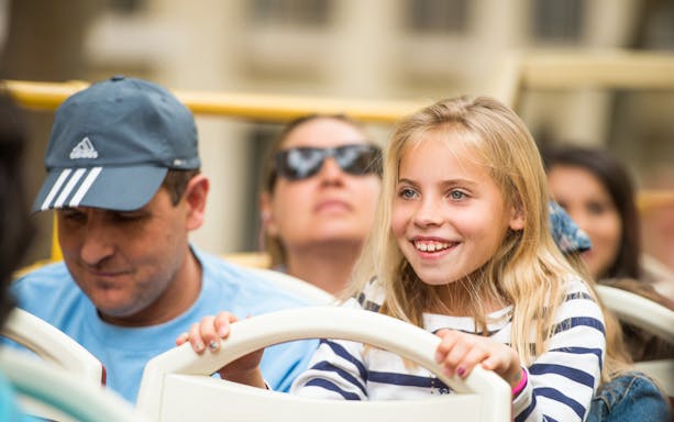 Children enjoying the view from a Munich hop-on hop-off bus tour.