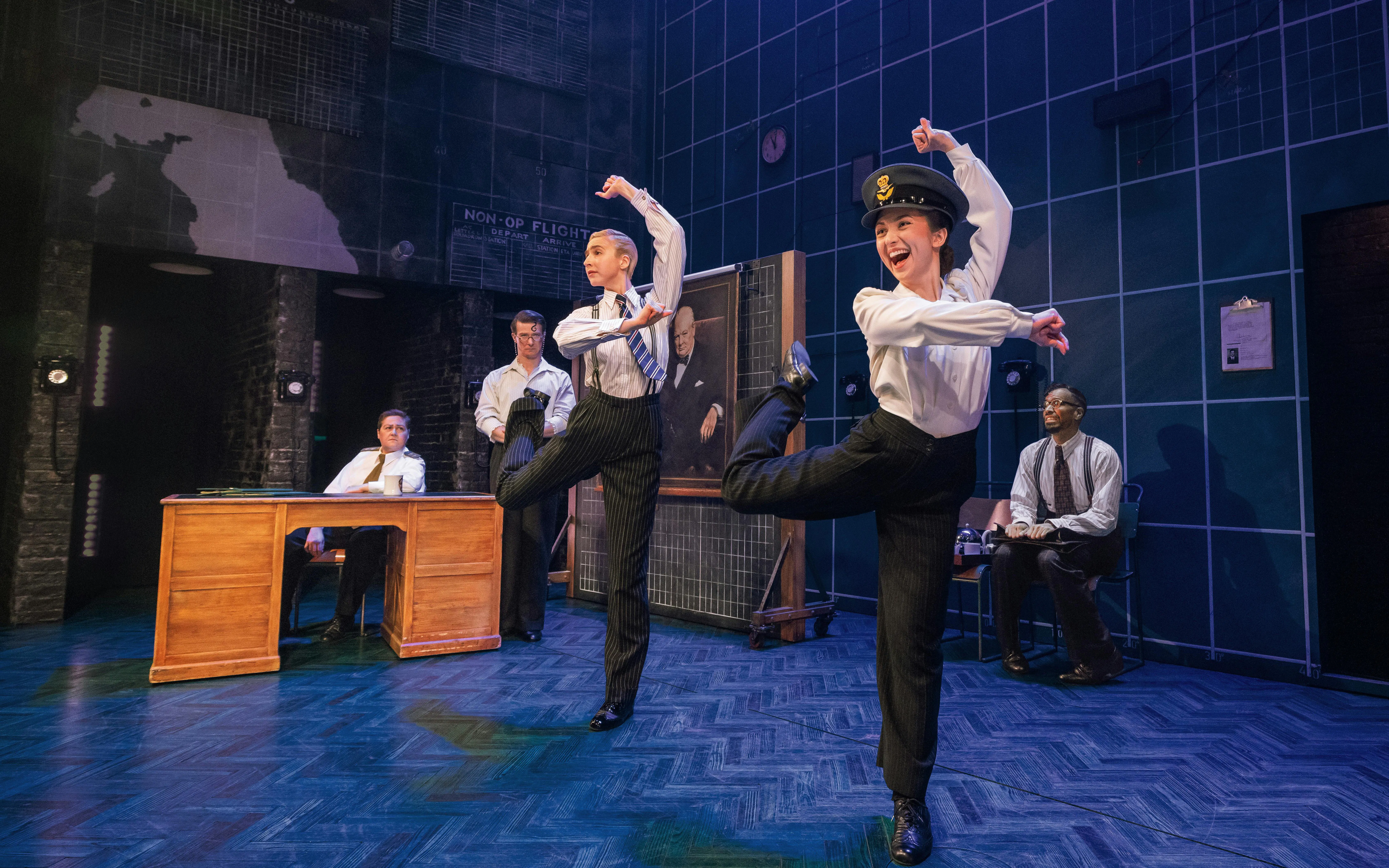 Performers dancing in a scene from Operation Mincemeat on Broadway stage.