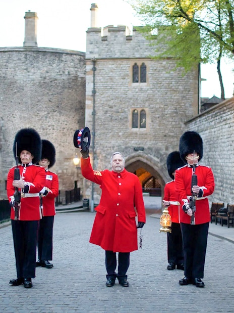 Guards in red uniforms at Tower of London during Ceremony of the Keys.