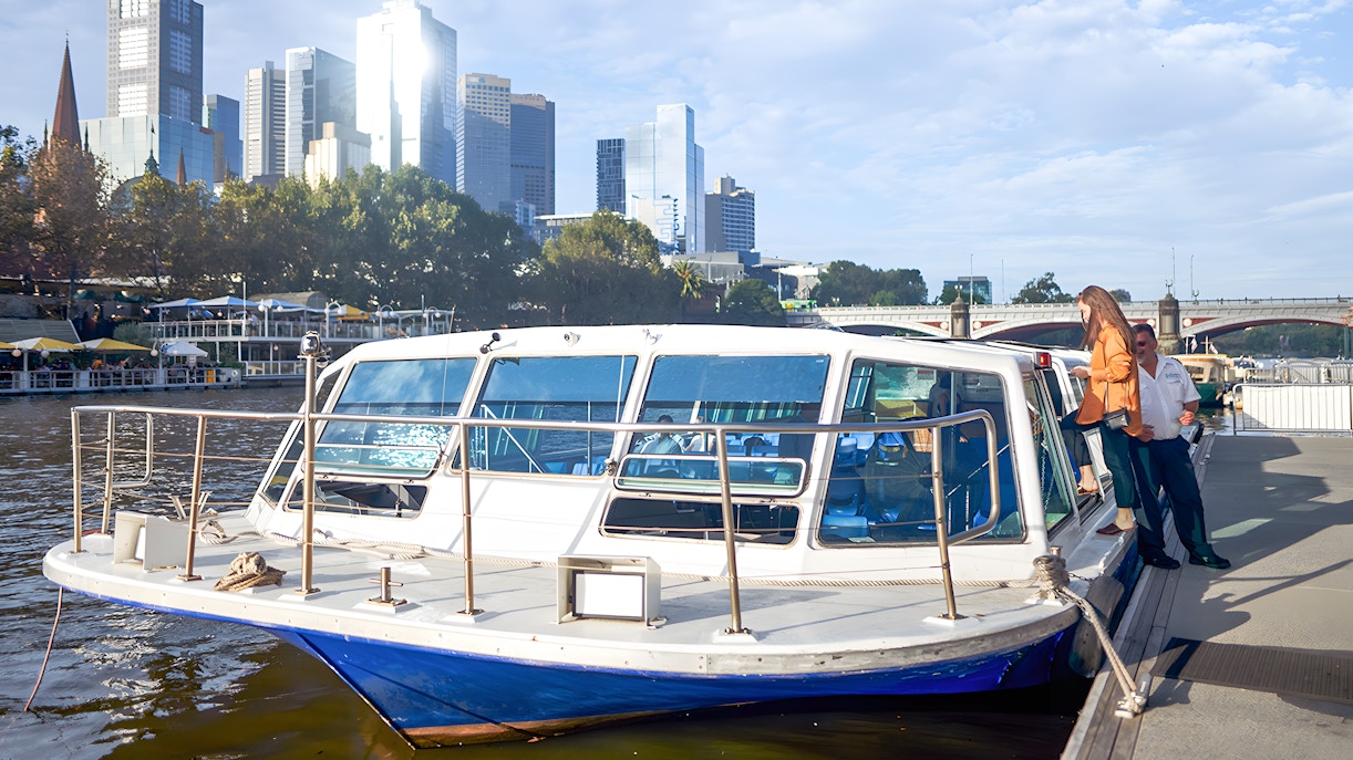 Yarra River sightseeing cruise with Melbourne skyline in the background.