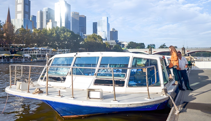 Yarra River sightseeing cruise with Melbourne skyline in the background.
