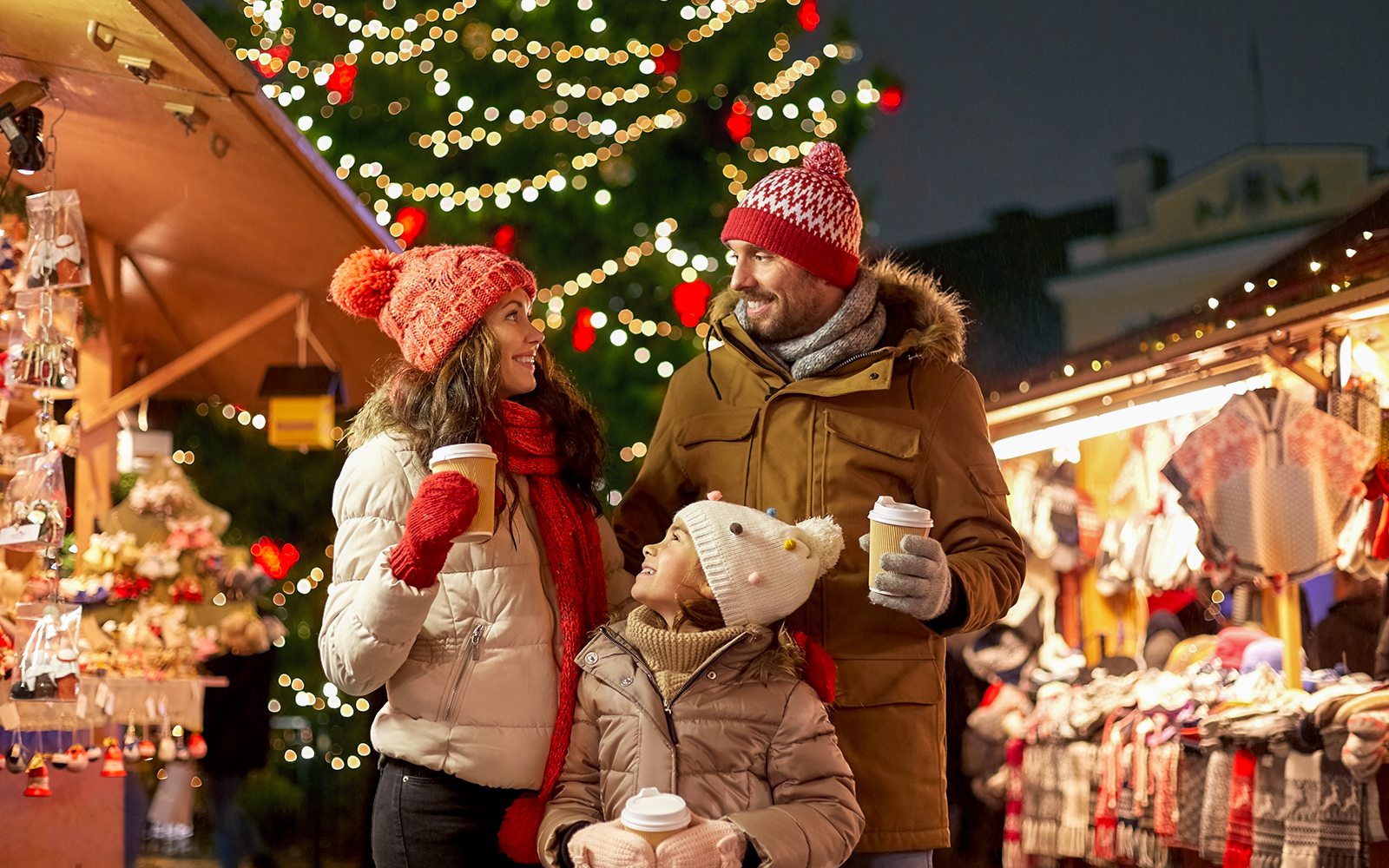 Christmas market stalls in barcelona with festive lights and decorations.