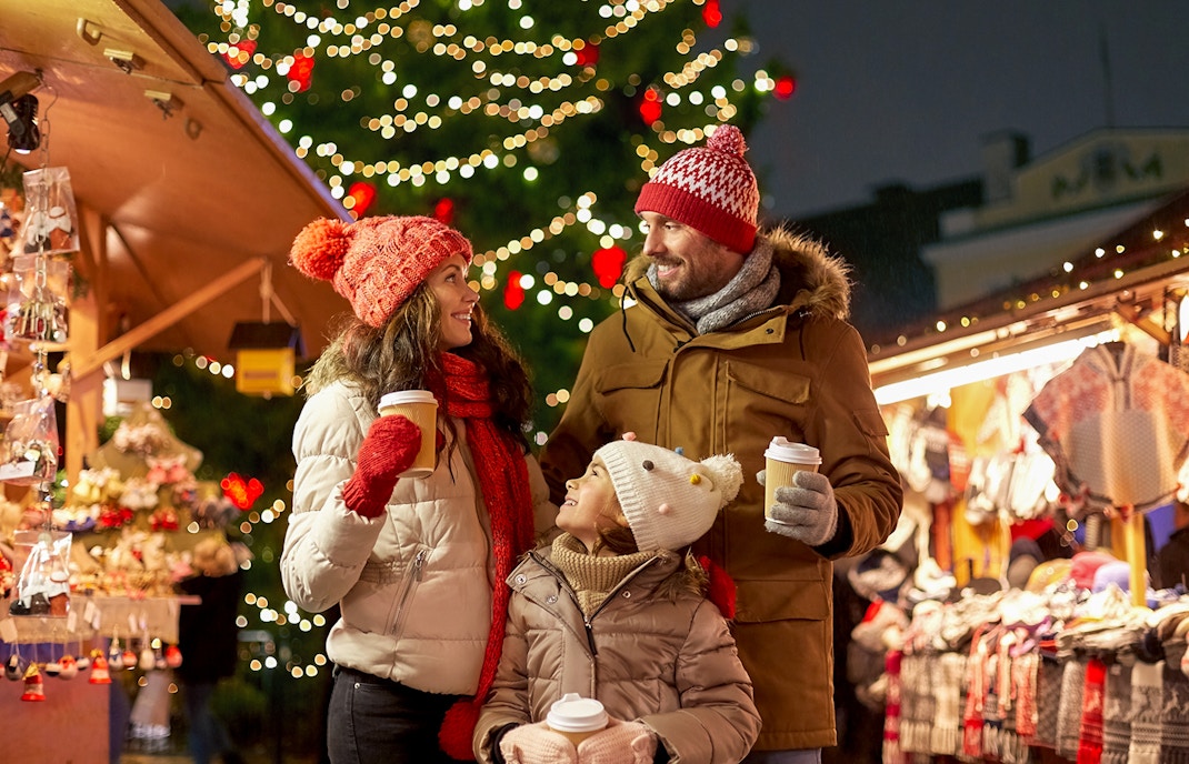 Christmas market stalls in barcelona with festive lights and decorations.