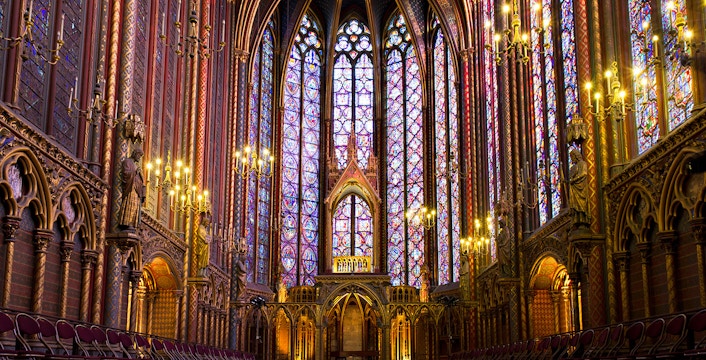 Visitors exploring the stunning stained glass windows of Sainte Chapelle in Paris, a unique feature of this guided tour