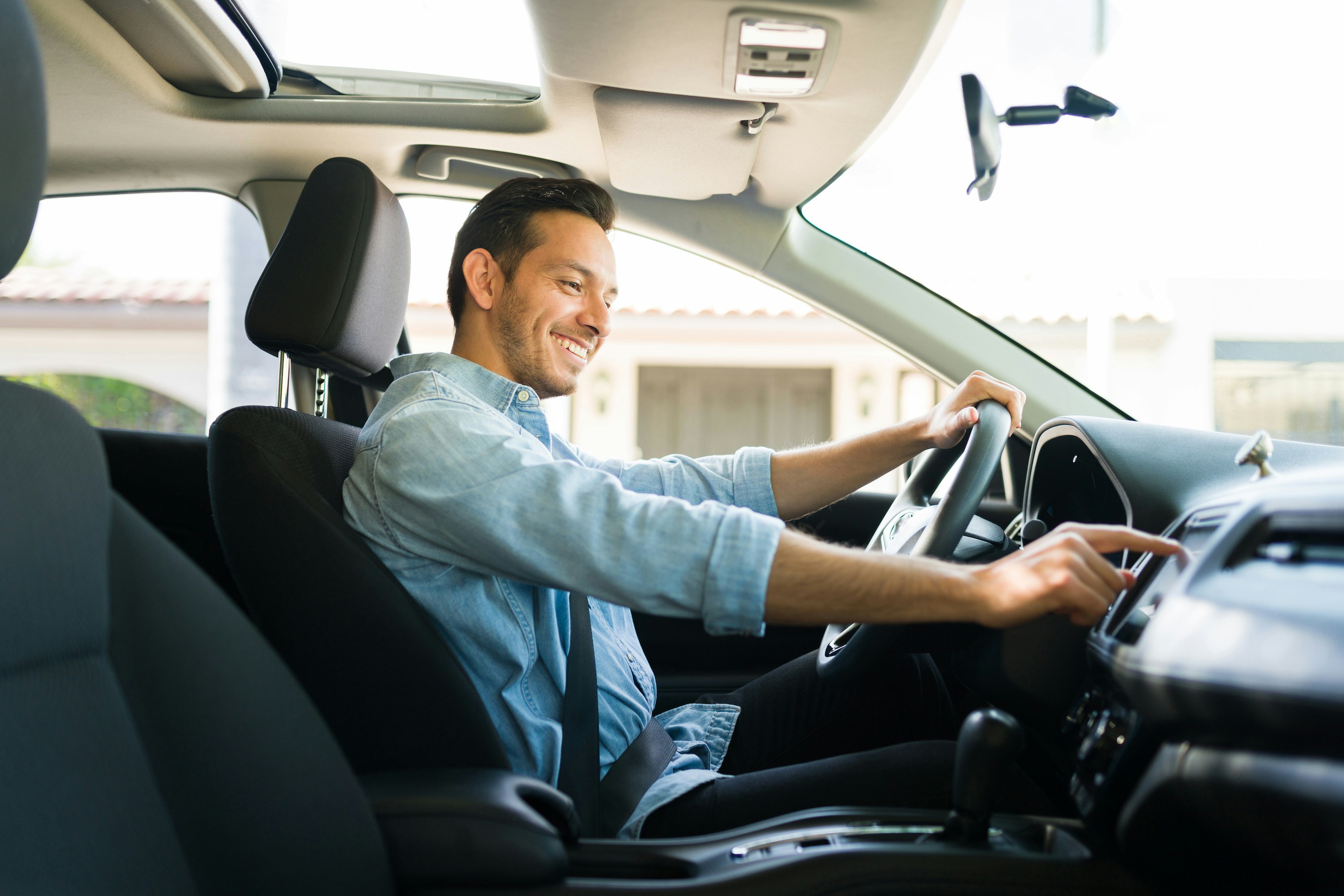 Man driving a car during a scenic road trip tour