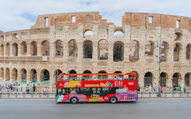 City sightseeing bus in front of the Colosseum, Rome.