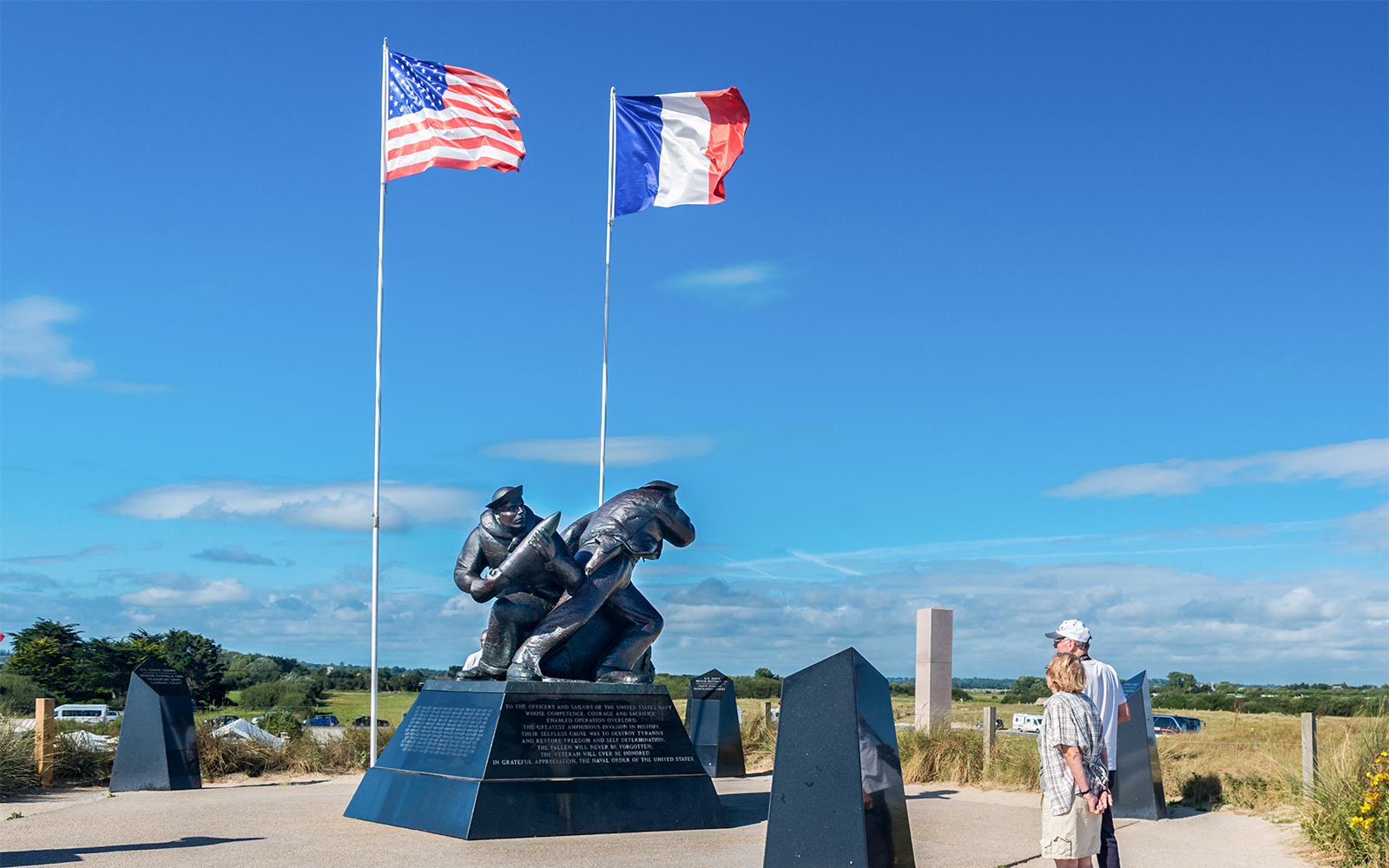 Normandy D-Day Tour guide explaining historical significance at Omaha Beach, France.
