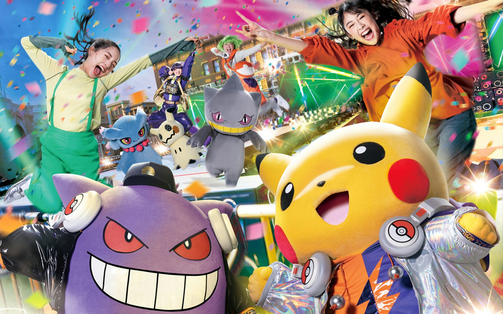Characters and visitors celebrating at Universal Studios Japan with confetti and vibrant lights.