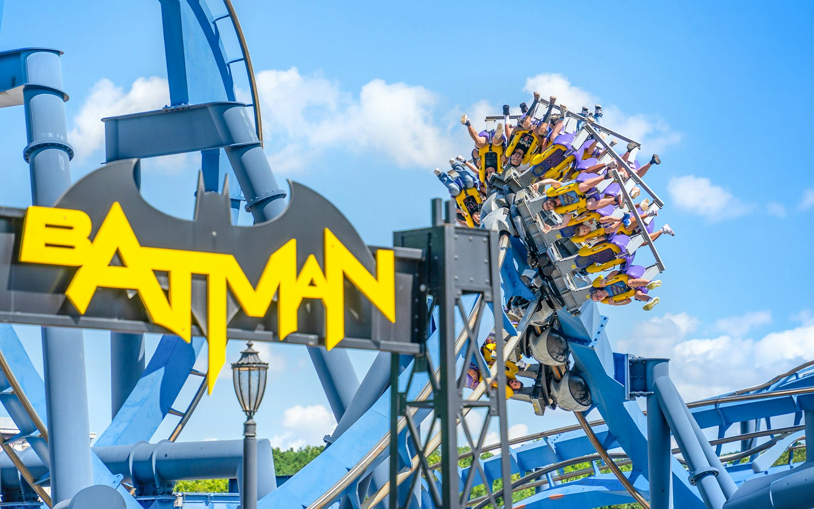 Riders on BATMAN™ The Ride roller coaster at Six Flags Over Georgia.