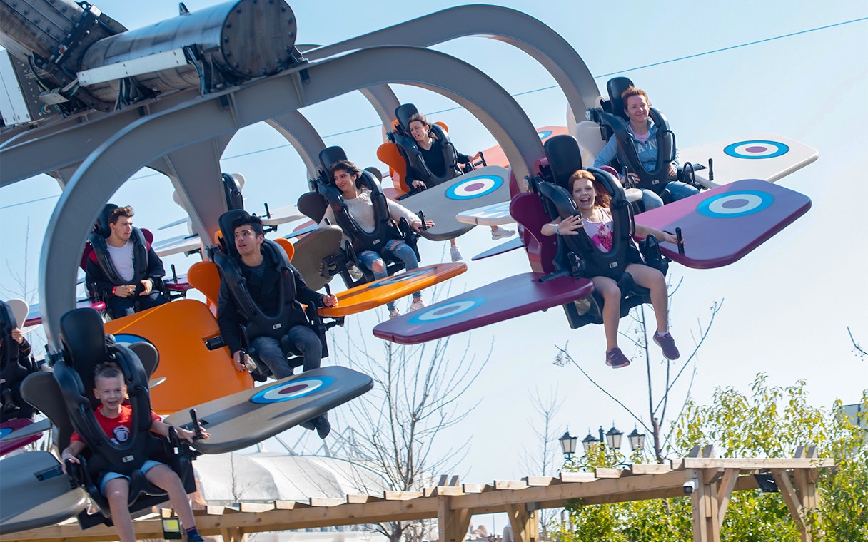 Visitors enjoying a flying ride at Land of Legends Theme Park, Antalya.