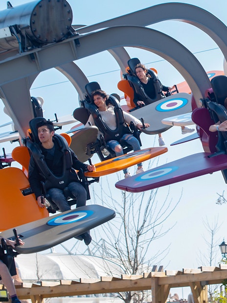 Visitors enjoying a flying ride at Land of Legends Theme Park, Antalya.