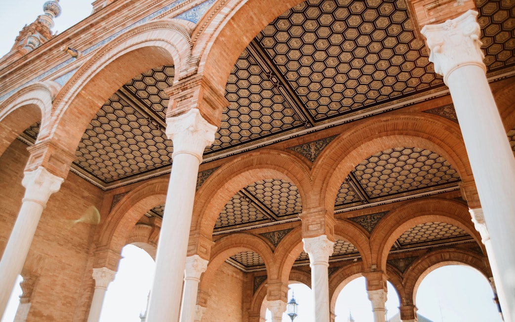 Arched ceilings and columns at the Royal Alcázar of Seville, Spain.