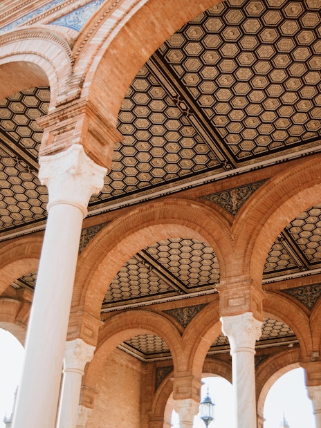Arched ceilings and columns at the Royal Alcázar of Seville, Spain.