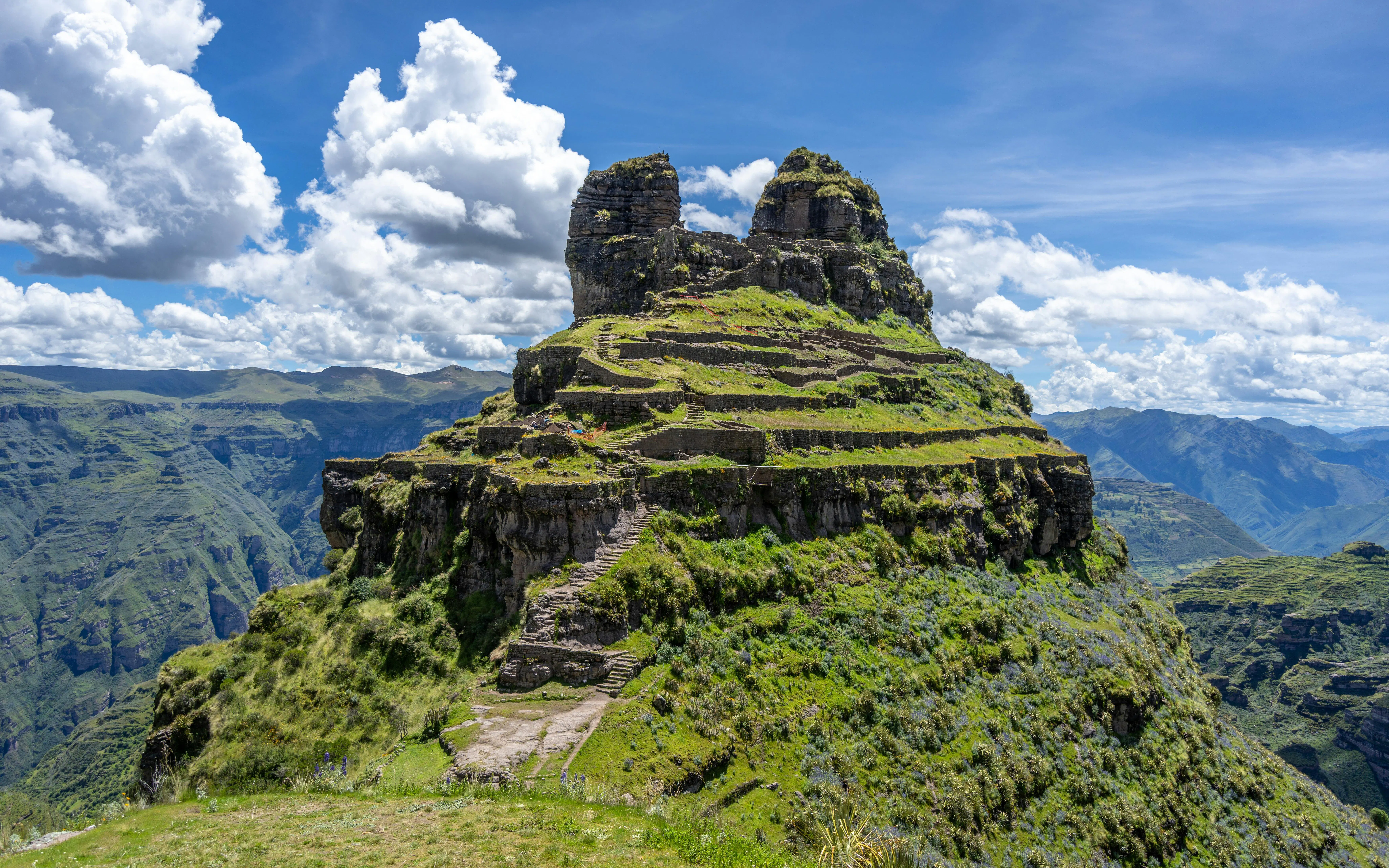 Ancient Inca ruins of Waqrapukara with terraced steps in the Andean Mountains, Peru.