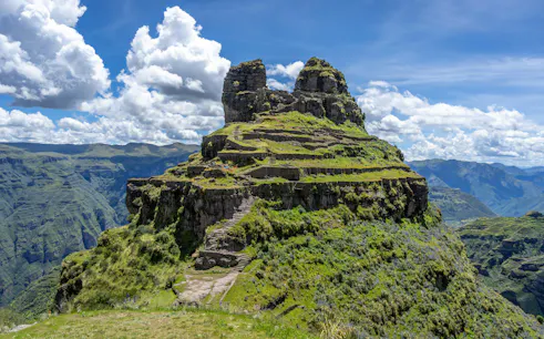 Ancient Inca ruins of Waqrapukara with terraced steps in the Andean Mountains, Peru.