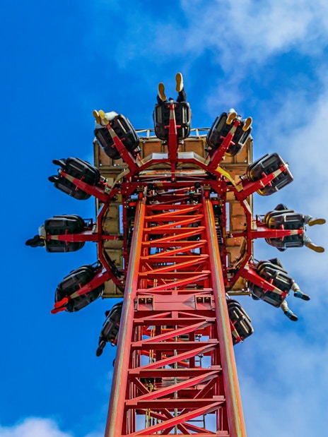 Thrill ride ascending at Thorpe Park against a blue sky.