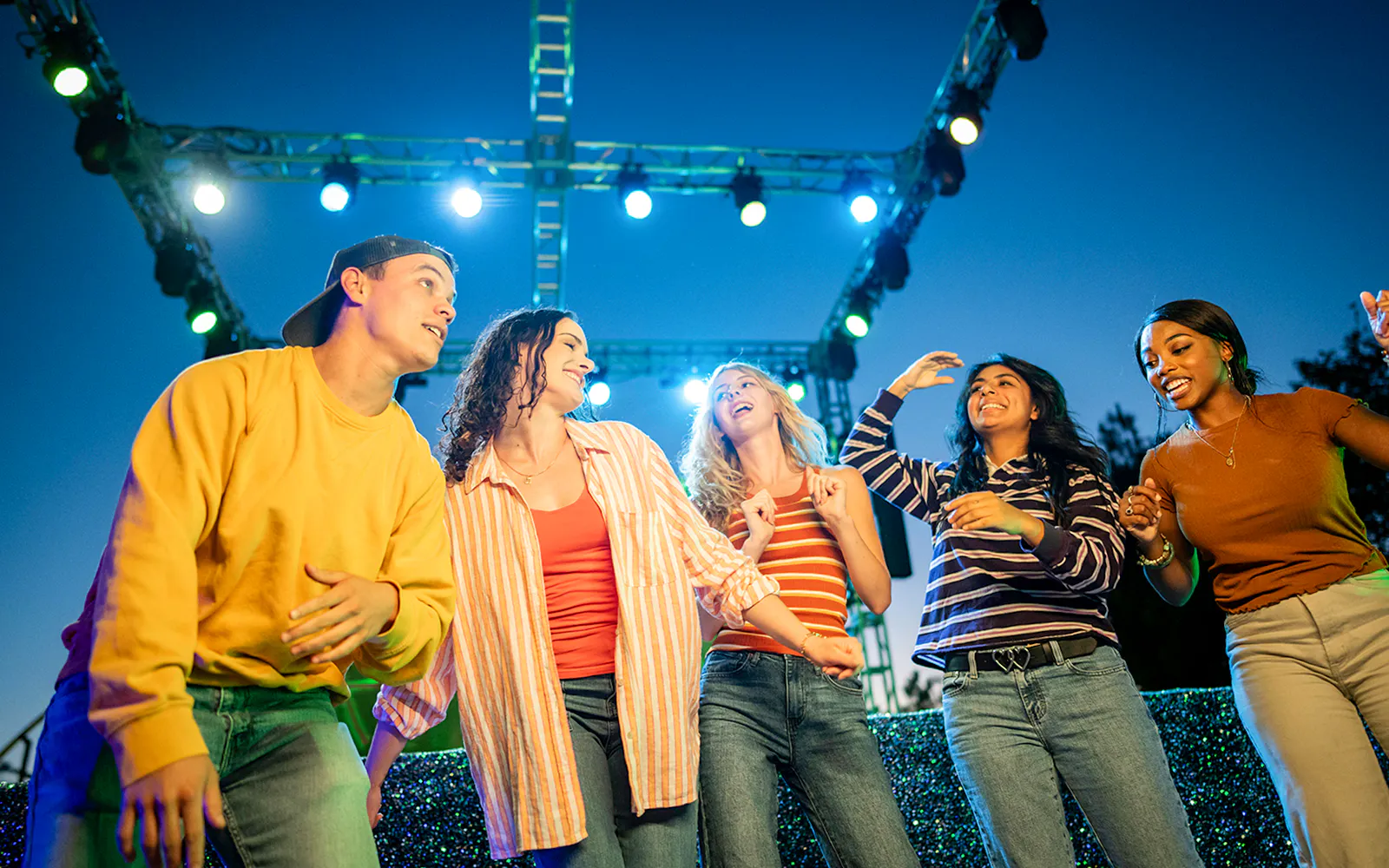 Guests enjoying Halloween Haunt zones at Dorney Park under colorful lights.