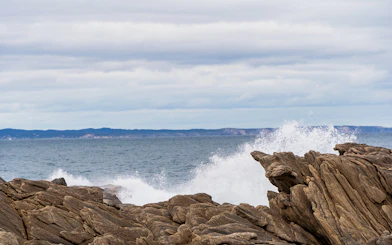 Waves crashing against rocks at Vivonne Bay Rock Pool, Kangaroo Island, South Australia.