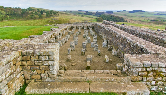 Housesteads Roman Fort ruins on Hadrian's Wall, Northumberland, England, showcasing ancient stone structures.