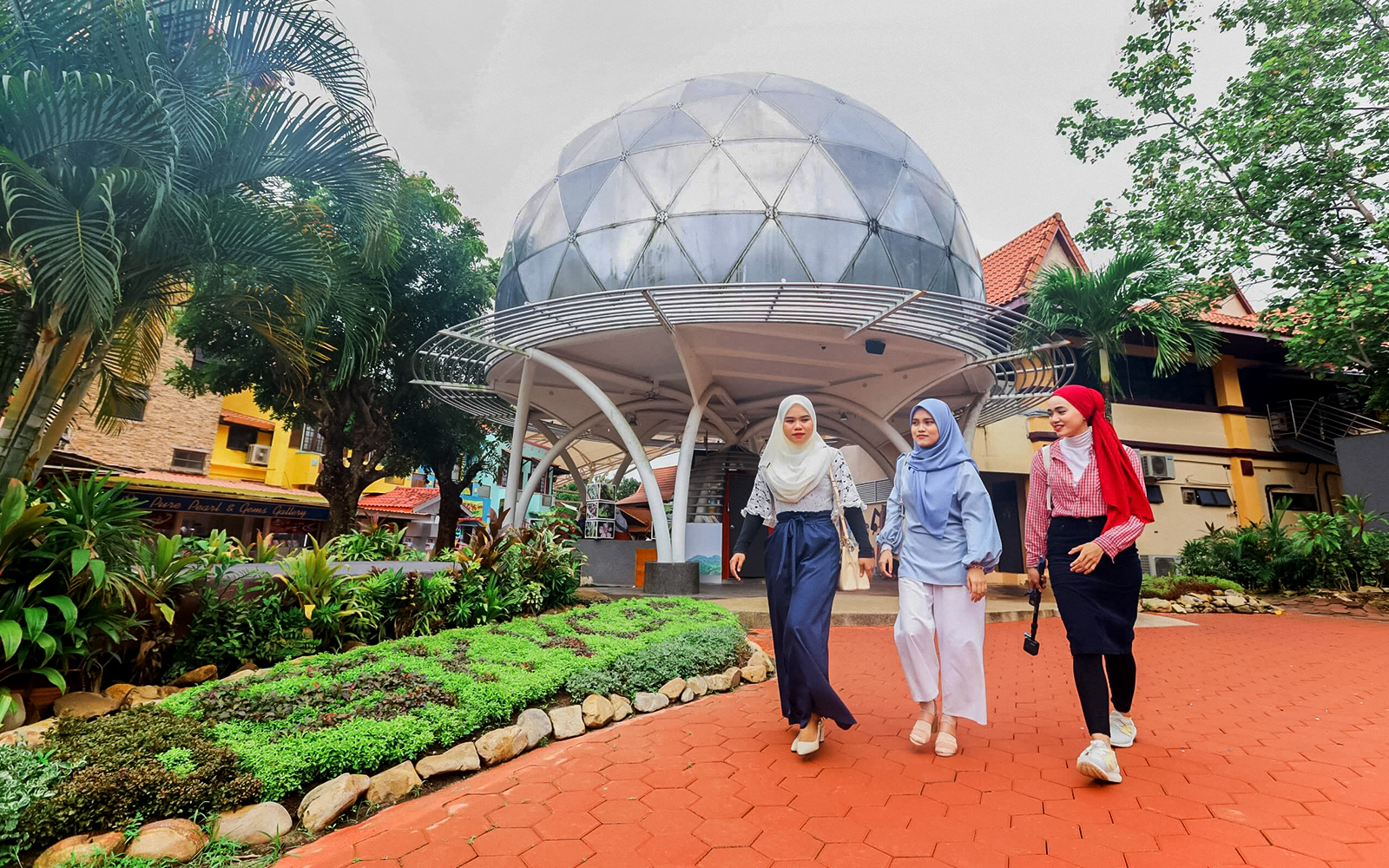 Tourists walking from SkyDome in a garden setting.