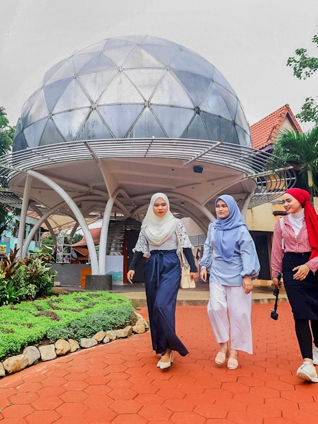 Tourists walking from SkyDome in a garden setting.