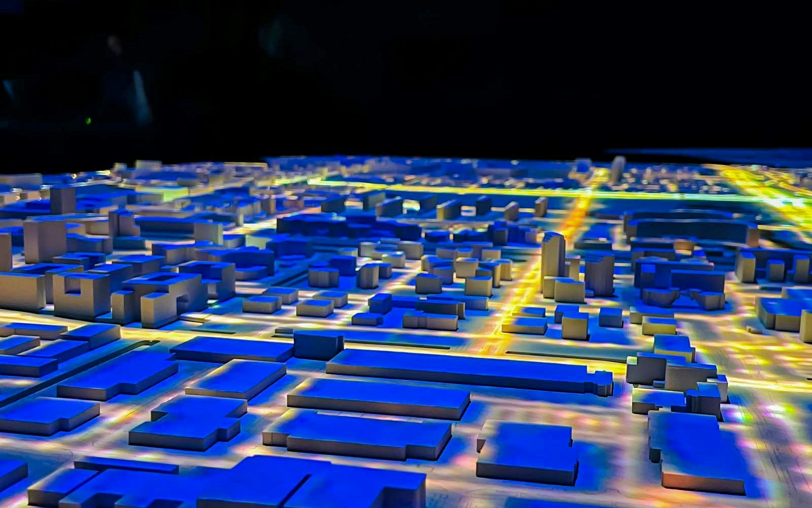 Amsterdam in Motion exhibit featuring illuminated cityscape model.
