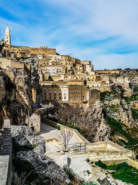 Matera's ancient stone buildings and winding paths on a guided tour.