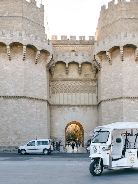 Tuk Tuk in front of Torres de Serranos, Valencia.
