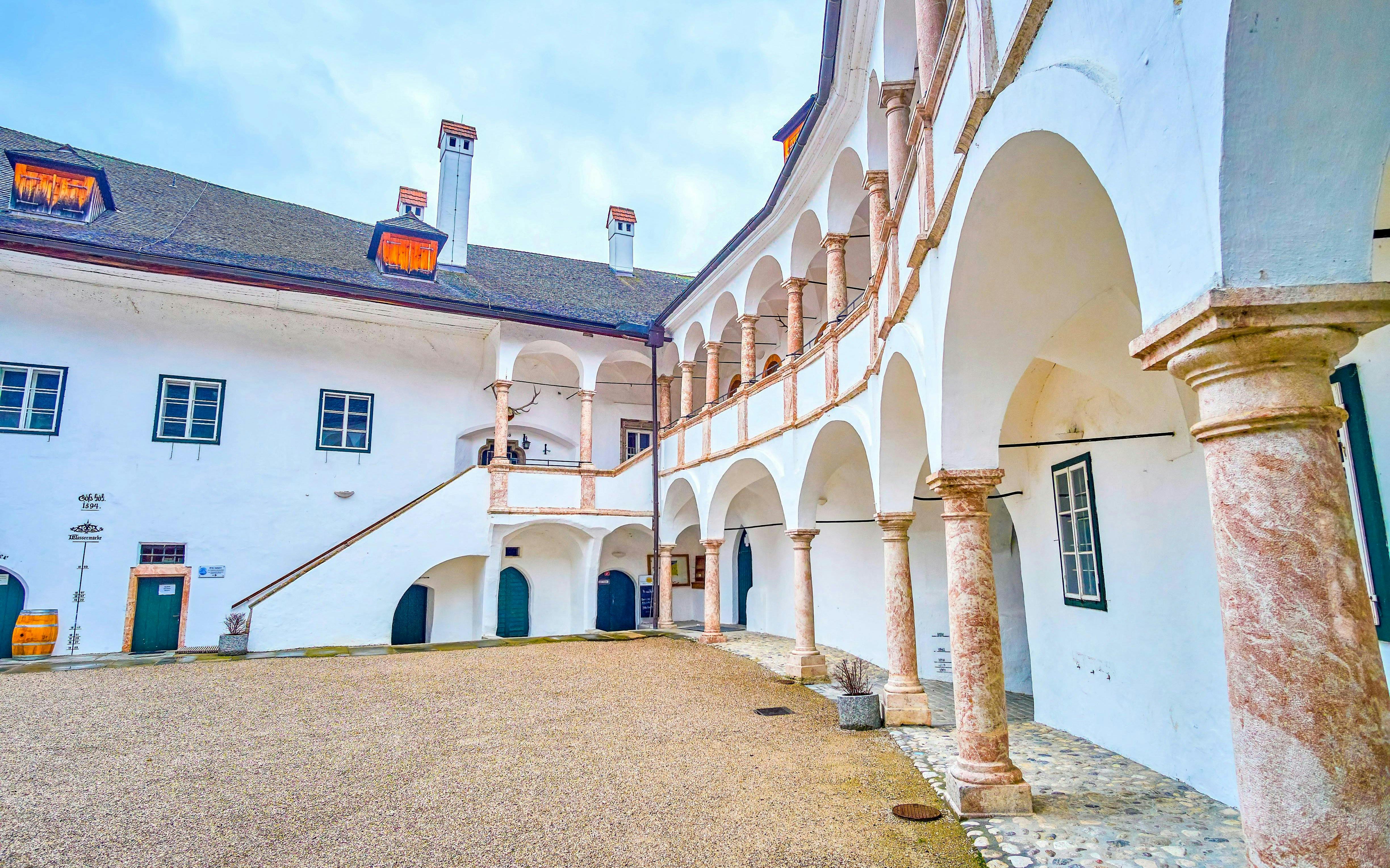 Schloss Ort courtyard with arched walkways and historic architecture in Hallstatt, near Vienna.