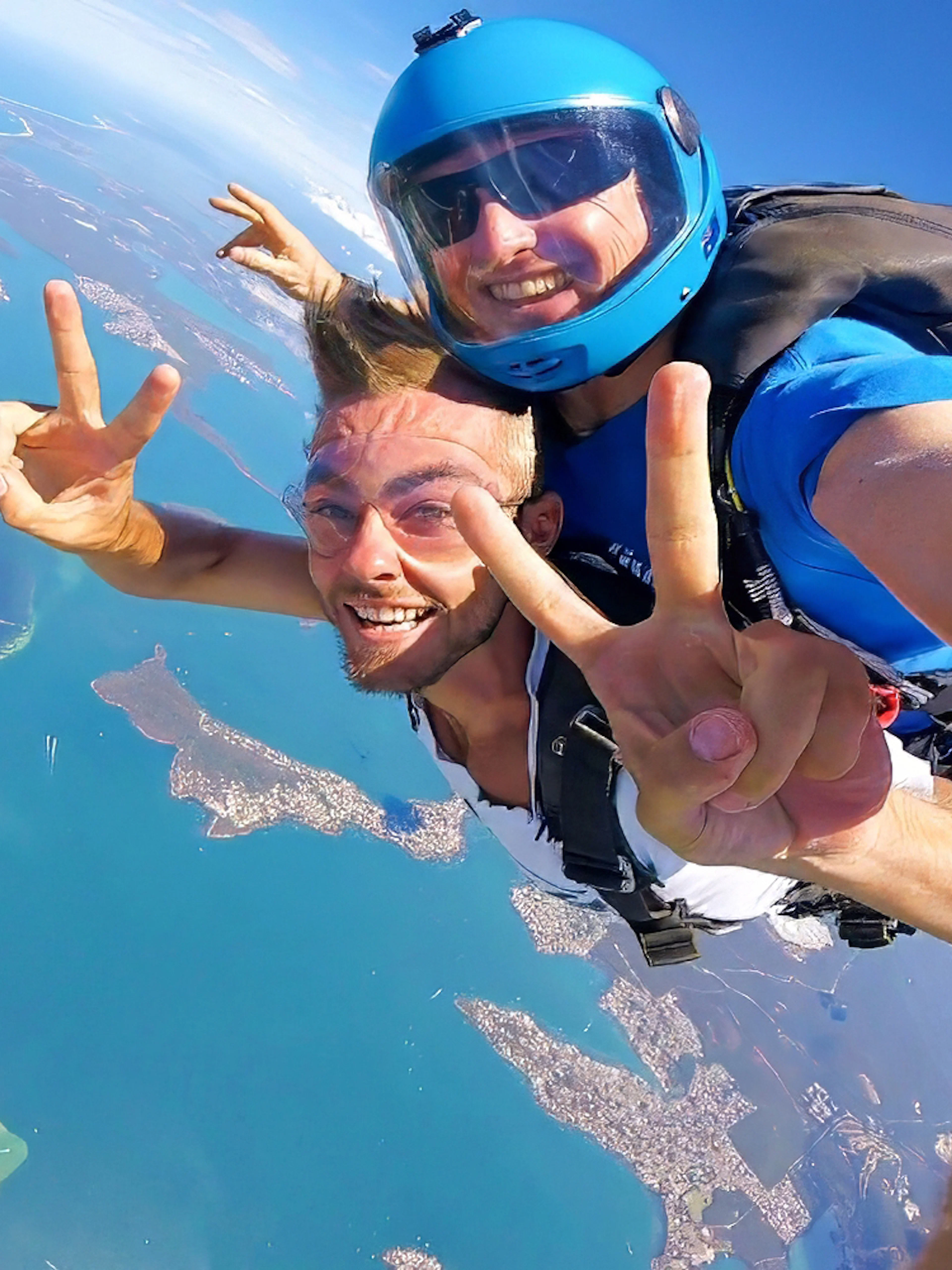 Tandem skydiving over Newcastle, Australia with ocean and city views.