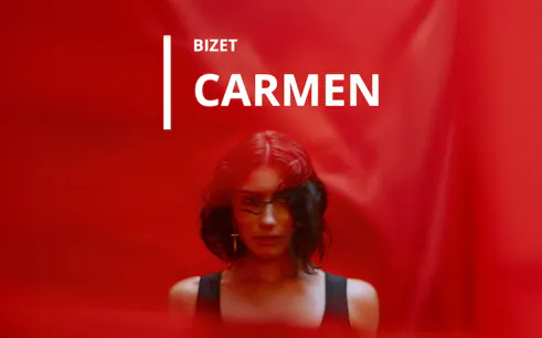 Bizet's Carmen opera poster with a woman against a red background.