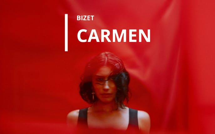Bizet's Carmen opera poster with a woman against a red background.