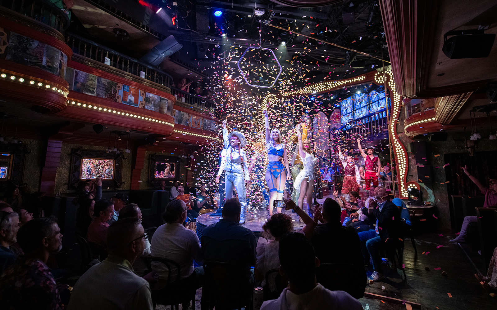 Performers on stage at the Atomic Saloon Show with confetti falling, Las Vegas.