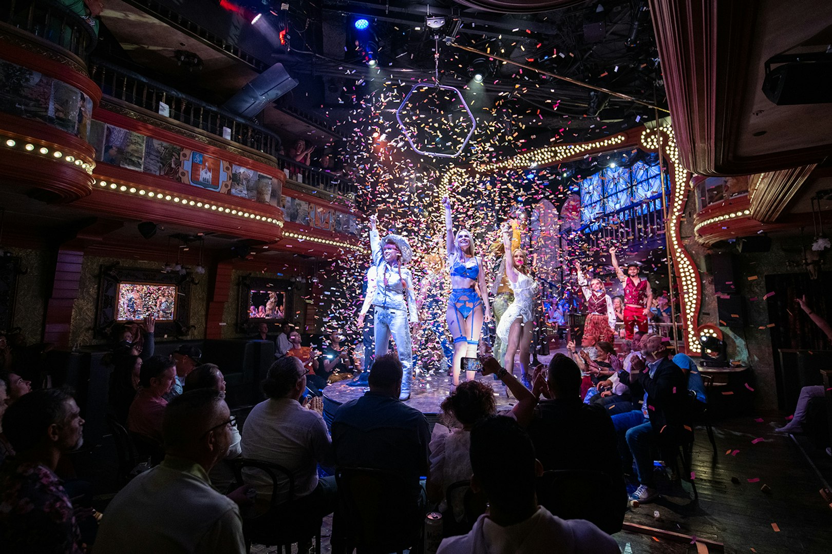 Performers on stage at the Atomic Saloon Show with confetti falling, Las Vegas.