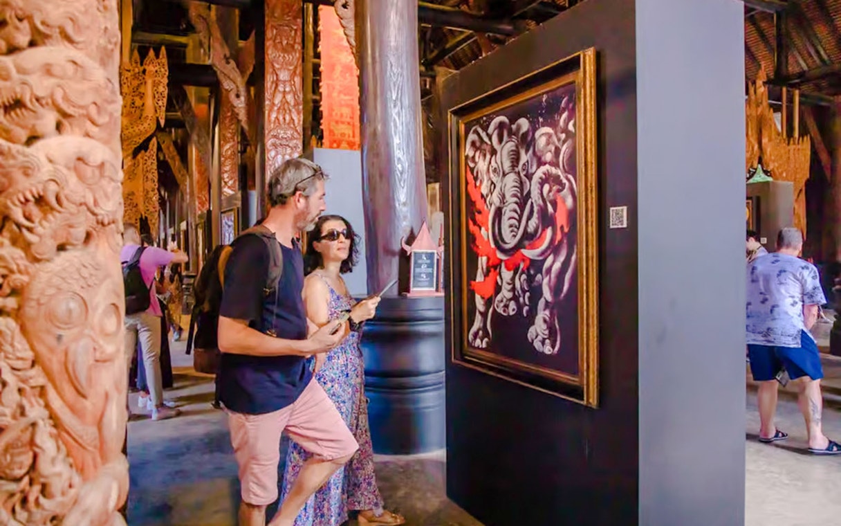 Tourists viewing elephant painting inside Black House (Baan Dam), Chiang Rai.
