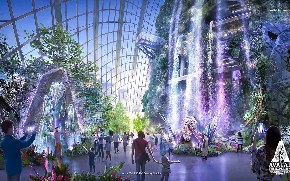 Visitors exploring the Avatar-themed Cloud Forest with waterfalls and lush greenery in Singapore.