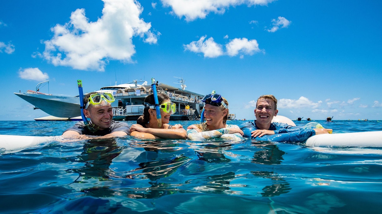 People snorkelling near a pontoon at the Great Barrier Reef.