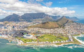 Cape Town cityscape with Table Mountain and Green Point Stadium.
